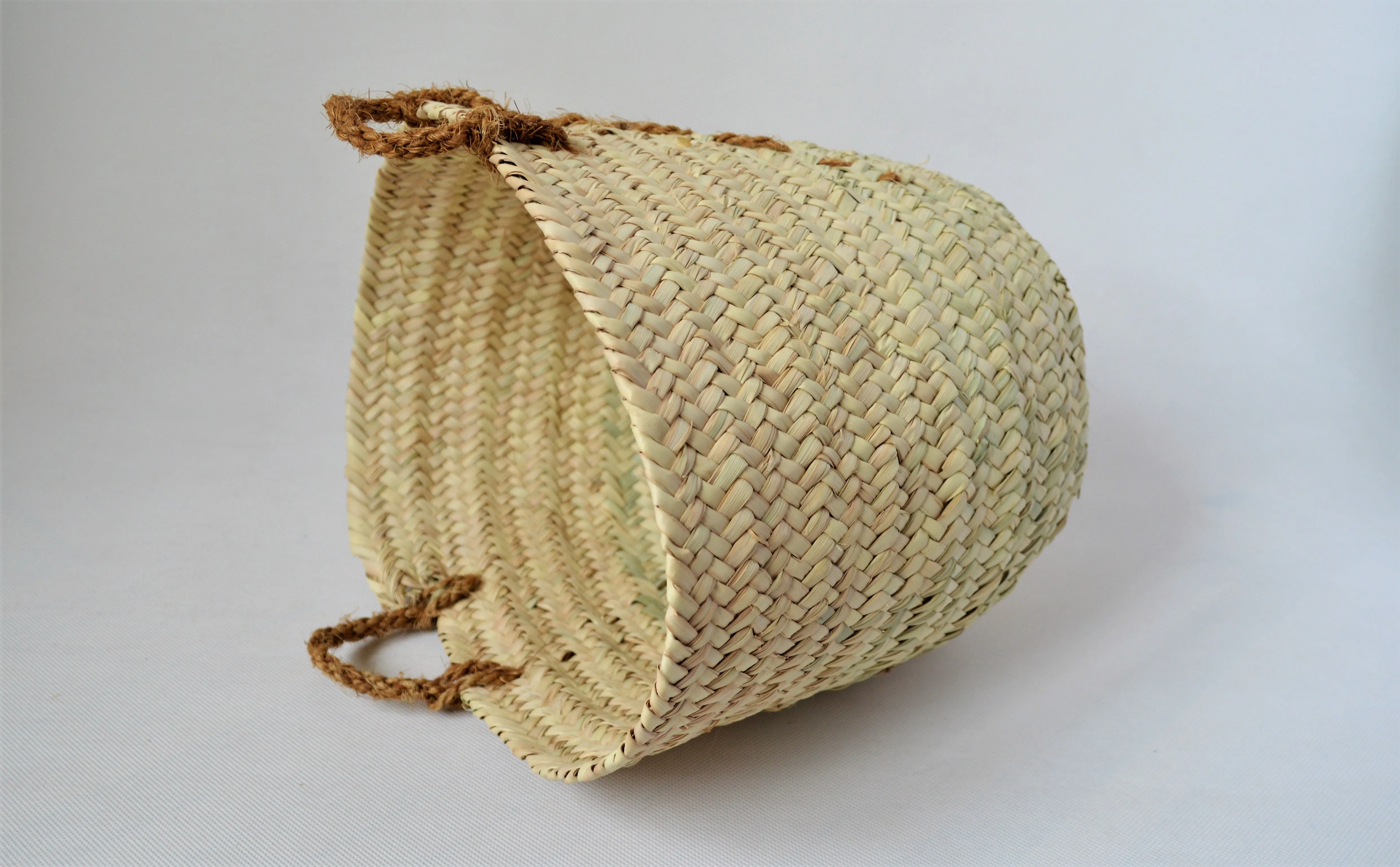 Natural palm straw basket with a strong natural handle from palm tree fibers